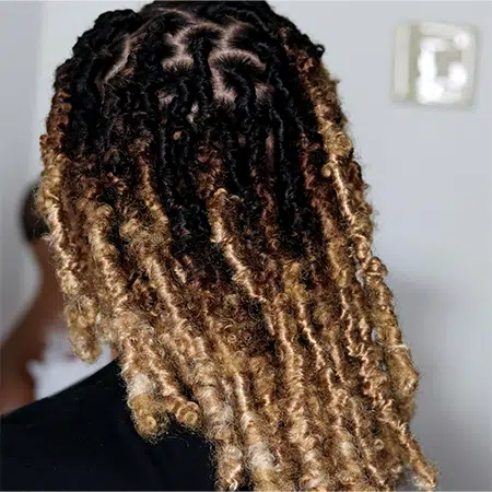 Female at salon wearing box twisted crochet gypsy goddess ombre brown faux locs