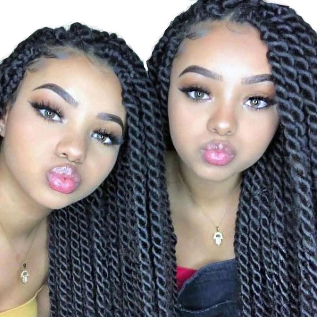 Two young light skin african girls with twisted passion crochet faux locs hair in black colors.