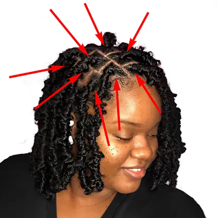 Red arrows pointing at point of reference for attaching short faux locs crochet indiviudals