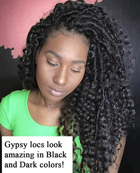 Black women with amazing features wearing green shirt on pink and black salon with thick crochet gypsy faux loc hair extensions freshly added and maintained.