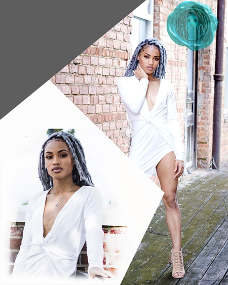 Black model queen wearing white dress in alley way near brick building with grey crochet faux locs hair silver platinum