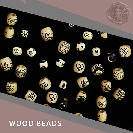About 50 wooden dreadlock beads sitting on black table for black womans faux locs hair