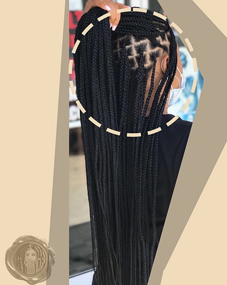 Light skin black girl with box sectioned knotless braids in black at long length.