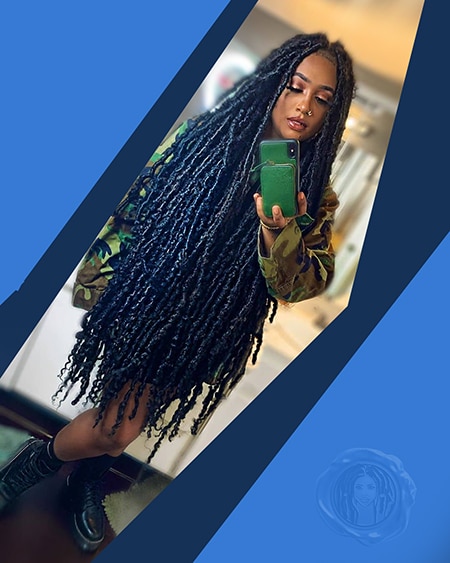 Light skin african queen with long black and dark blue crochet faux locs hair extensions in a bathroom selfie.