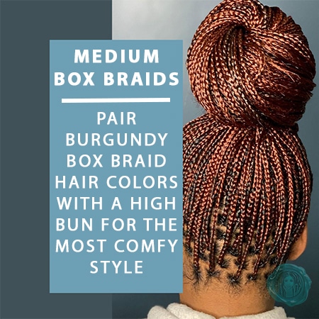 Medium burgundy box braids on african woman with her box braids all up in a high bun updo.