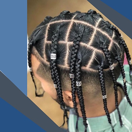 Evenly sectioned box braids hair with dreadlock accessories on light skinned male wearing a teal shirt.