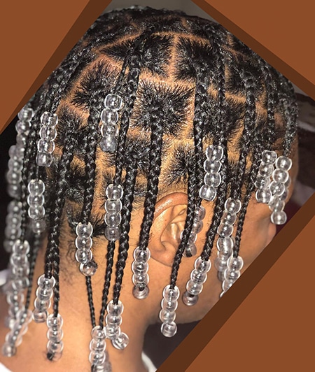 African american wearing beaded mens box braids hairstyles with natural hair.