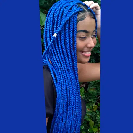 Light skinned black teen with sapphire blue color braids.