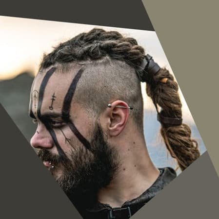 Iconic main character from the viking series with long braided viking braids and shaved hair sides of his head.